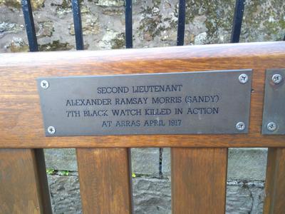 a plaque on a memorial bench